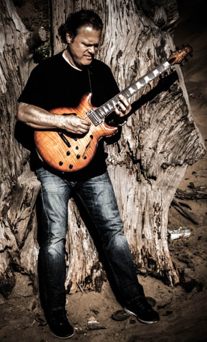 Doug Cameron playing electric guitar.